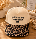 Put It On My Husband’s Tab Trucker Hat